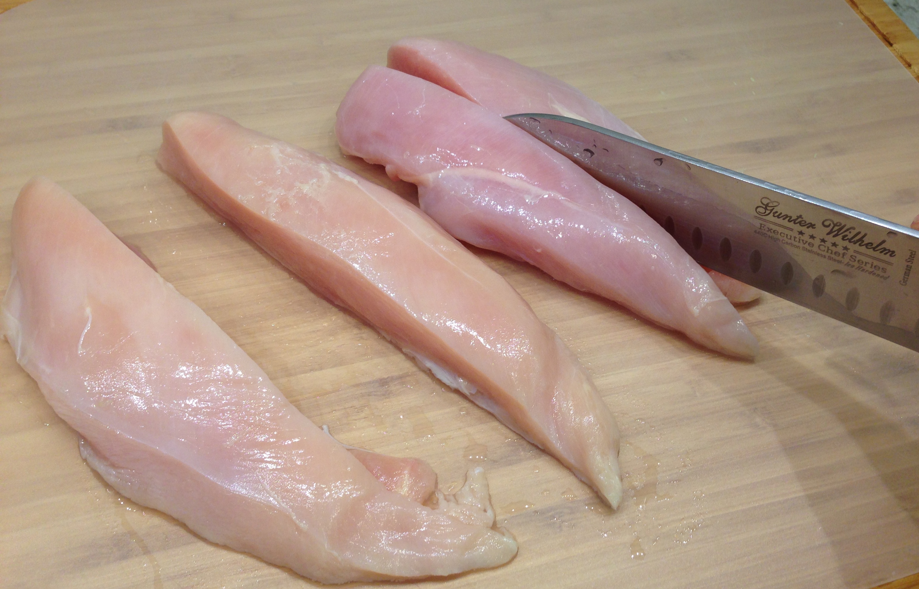 Cut chicken breasts in half